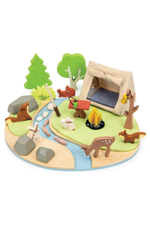 Wooden camping playset with tent, campfire, trees, and wildlife figures on a circular base. Eco-friendly and colorful.