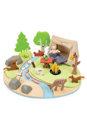 Wooden camping playset with tent, doll, campfire, animals, trees, and stream on a wooden base. Eco-friendly design.