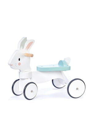 A cute white wooden ride-on toy shaped like a rabbit, featuring non-slip wheels and a mint green seat.