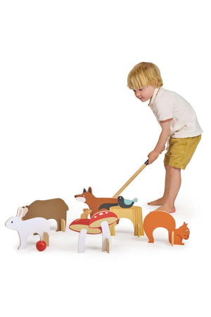 A young child plays croquet with colorful wooden animal-themed hoops and mallets, showcasing sustainable, family-friendly design.