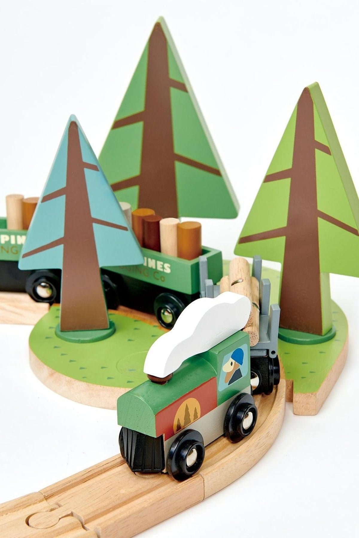 A colorful wooden train set features a green engine and three carriages transporting logs, surrounded by stylized wooden trees. This sustainable toy encourages imaginative play and storytelling for young children.