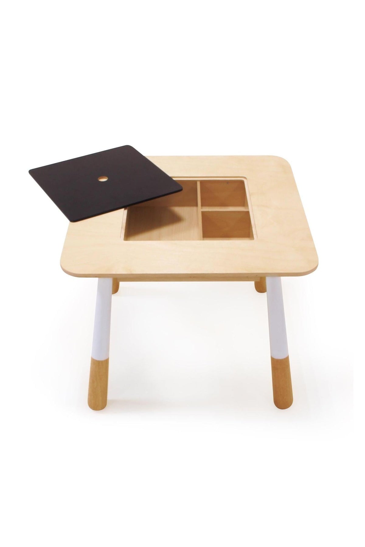 Wooden toddler table with white legs features a removable black chalkboard panel revealing storage compartments underneath.