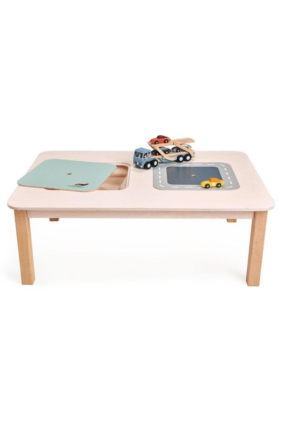 A spacious wooden play table in soft pink features two canvas storage compartments and reversible lids.