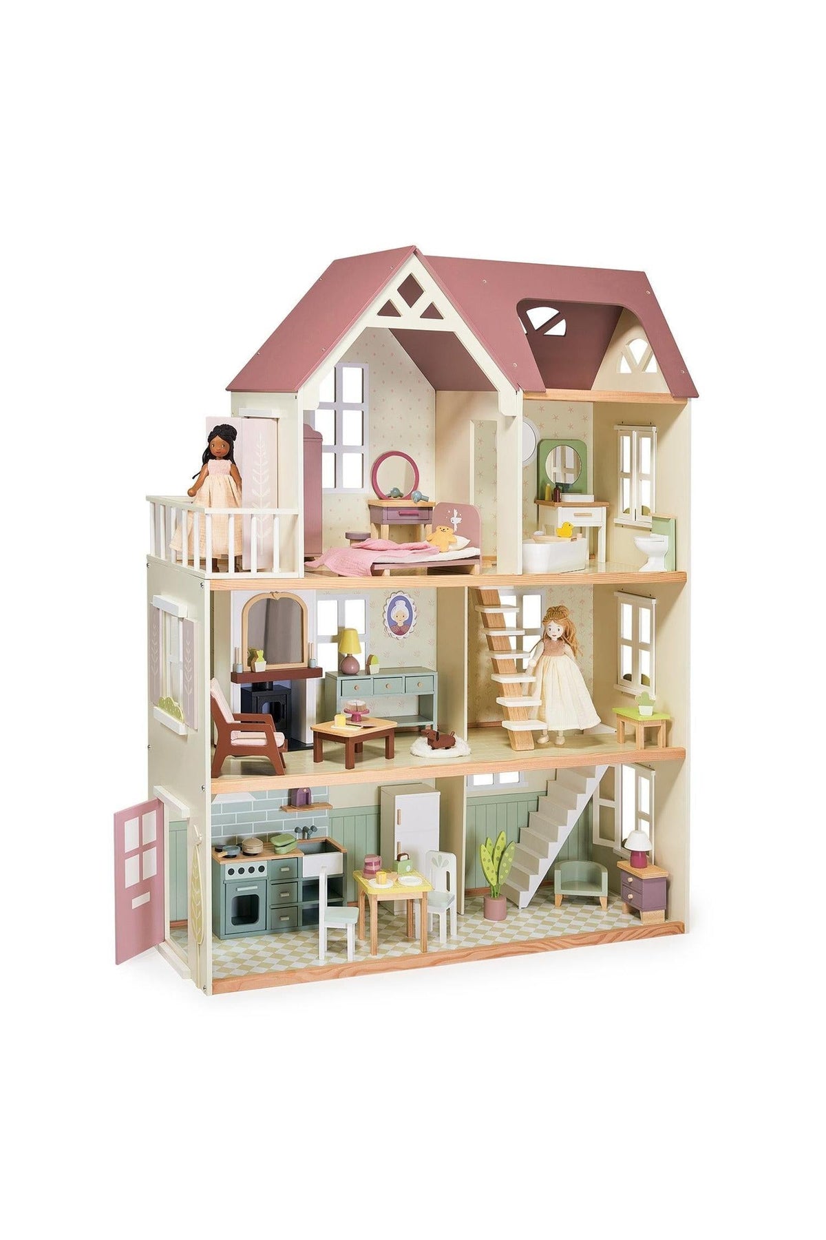 A beautifully designed wooden dollhouse features multiple rooms, including a kitchen and living area, with two dolls positioned inside. The house has a charming pastel color scheme and detailed furnishings.