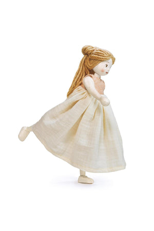 A handcrafted wooden doll named Ferne features a light beige dress and long, blonde hair. Made from sustainably sourced rubber wood, she is designed for imaginative play and cherished memories.