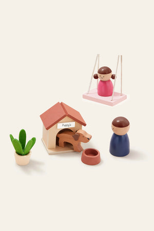 A colorful wooden playset features a doll on a swing, a doghouse with a dog, and a figure holding a bowl, all set against a light background for imaginative play.