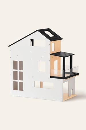 A modern dollhouse featuring a minimalist design with a white exterior, wooden accents, and a black roof. Ideal for imaginative play, it encourages creativity and storytelling for children.