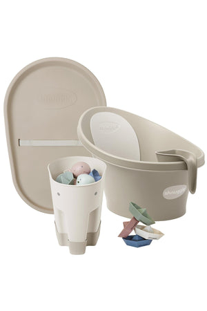 Shnuggle bathtime essentials bundle in taupe, featuring a baby bath, rinse jug, changing mat, and toy boats.