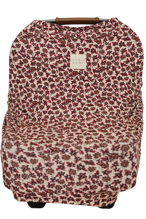 A floral-patterned nursing cover made from soft, breathable bamboo fabric features a ribbed texture. It is designed for versatile use, including as a car seat or shopping cart cover.