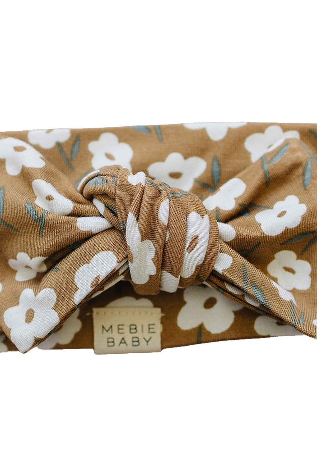 A mustard floral head wrap featuring white flowers and green leaves, made from soft bamboo fabric.