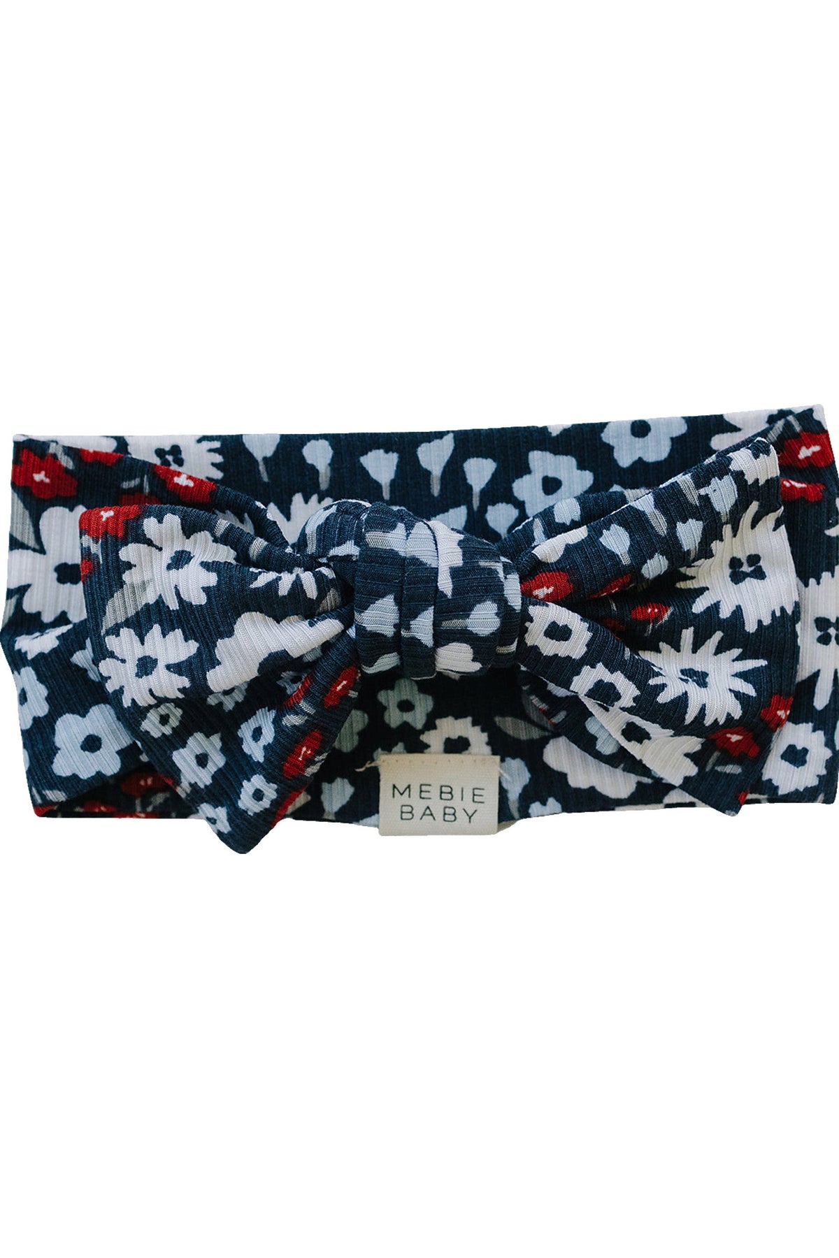 Floral ribbed head wrap with red, white, and navy flowers. Made from bamboo fabric, labeled Mebie Baby.
