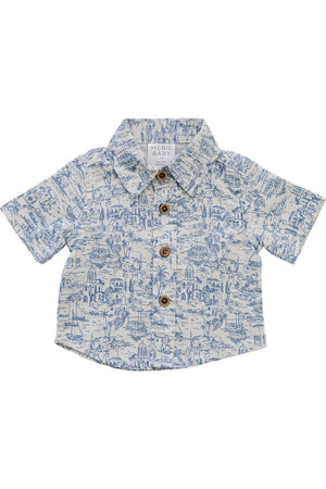 Light blue and white linen button-up shirt from Mebie Baby features a playful coastal print and wooden buttons. Ideal for beach outings, it combines comfort and style for young boys.