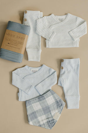Mebie Babys blue stripe pointelle layette set features soft, breathable cotton outfits, including a long-sleeve top, pants, and a plaid bib, ideal for newborns.