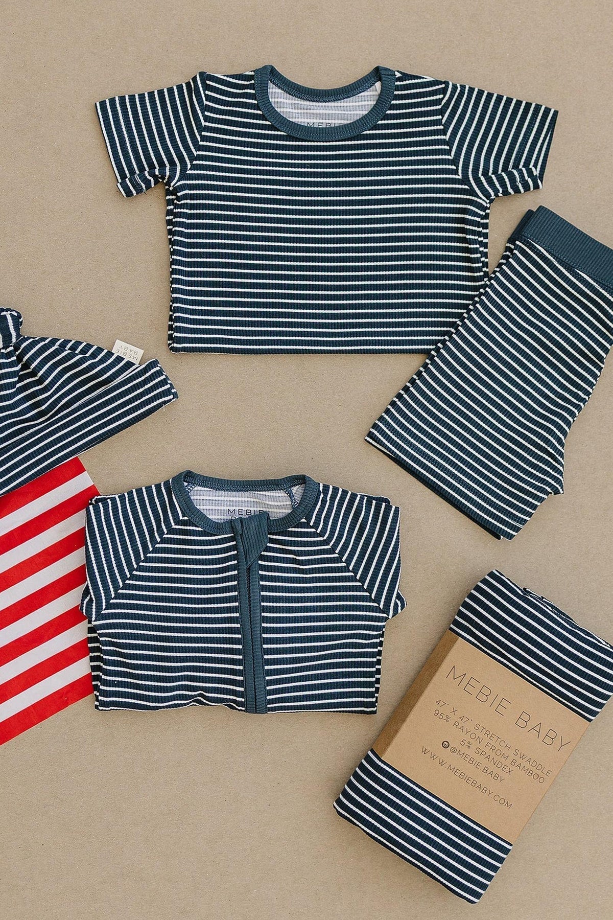 Navy and white striped baby clothing set includes a shirt, pants, and hat, made from soft bamboo fabric.