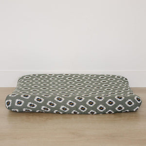 A soft muslin changing pad cover featuring a Southwest Aztec design in earthy tones, perfect for adding a modern western touch to nursery decor.