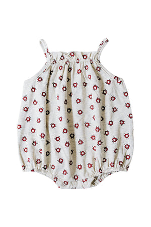 Light cream bubble romper featuring a floral pattern in red and black, made from soft cotton fabric with elasticized straps.
