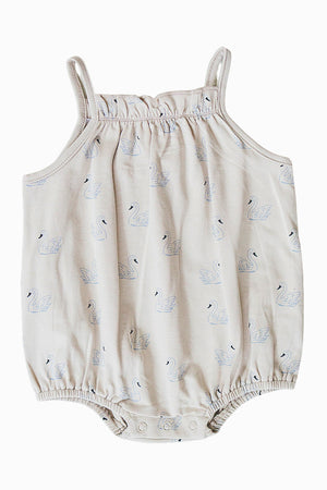 Cream tank bubble romper featuring a swan print, made from soft cotton fabric with elasticized leg openings and snap closures.