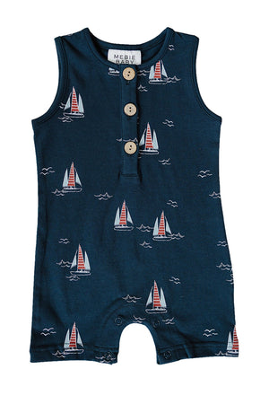 Navy blue cotton romper featuring a playful sailboat print in red and white, with a button placket at the front. Ideal for baby boys aged 0-2T, combining comfort and style.