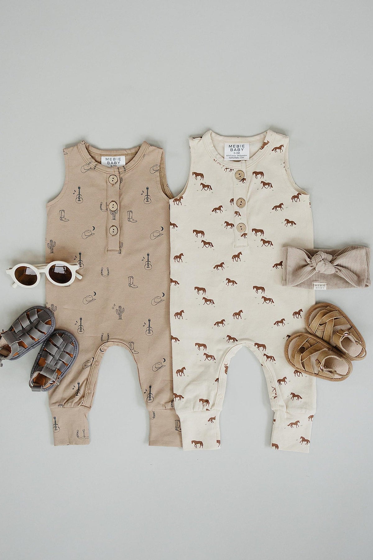 Two cotton tank rompers in beige and cream with western-themed graphics, paired with sandals, a headband, and sunglasses.
