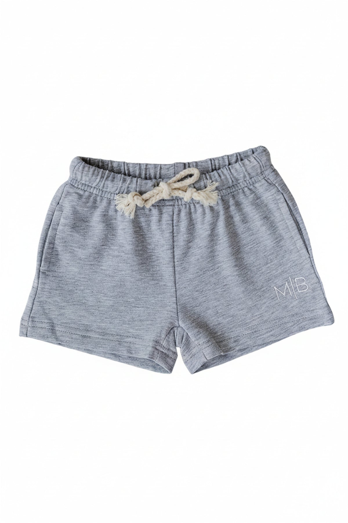 Soft grey cotton shorts featuring an elastic waistband with a drawstring and side pockets, perfect for kids play. Ideal for all-day comfort and versatile styling options.