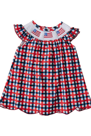 A vibrant red, white, and blue gingham dress featuring a smocked collar with embroidered American flags, perfect for patriotic celebrations. Made from soft cotton, suitable for young children.