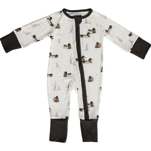 A ribbed bamboo zipper pajama features a playful duck pattern on a light background, with dark brown cuffs and foot openings, designed for comfort and easy diaper changes for babies.