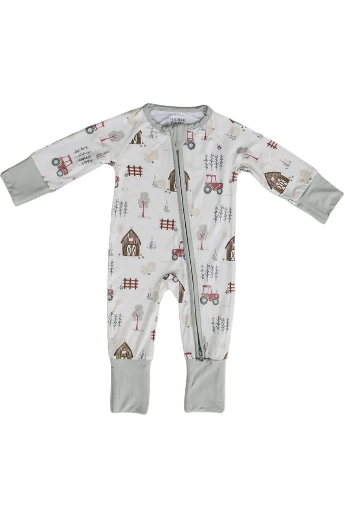 A bamboo zippered pajama in a soft gray color features a playful farm-themed print with tractors, barns, and trees. Ideal for babies, it allows for easy diaper changes and comfort.