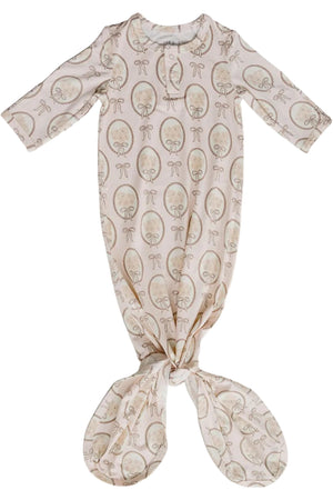 A vintage bouquet bamboo knot gown features a soft, neutral fabric adorned with floral patterns. Designed for babies aged 0-3 months, it offers comfort with its eco-friendly bamboo rayon material.