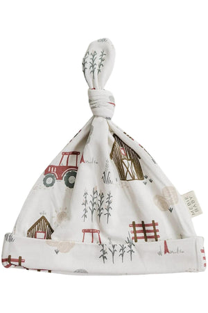 A soft bamboo newborn knot hat featuring a charming farmhouse print with tractors, barns, and crops. The hat is designed for comfort and style, perfect for your little one.
