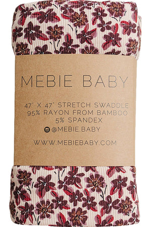 A rolled-up swaddle from Mebie Baby, featuring a delicate floral print in burgundy and cream. Made from 95% bamboo rayon, it offers soft, breathable comfort for newborns.