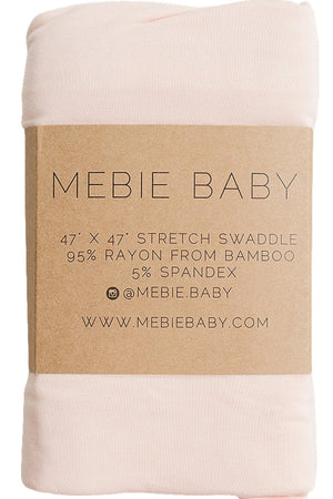 A soft peach bamboo stretch swaddle from Mebie Baby, measuring 47” x 47”, features a label highlighting its composition of 95% rayon from bamboo and 5% spandex. Ideal for newborns.