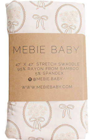 A folded swaddle featuring a vintage floral design, made from 95% bamboo rayon and 5% spandex.