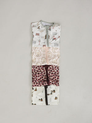 A collection of Ducks ribbed bamboo zipper pajamas for babies features various whimsical patterns in soft, eco-friendly fabric. The pajamas are designed for easy diaper changes and comfort.
