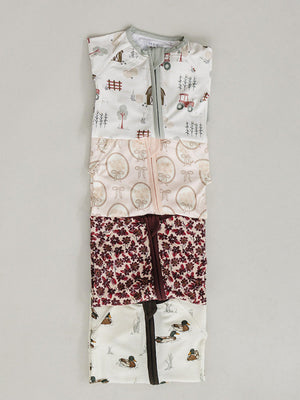 A collection of bamboo zipper pajamas in soft colors, featuring playful patterns of trees, animals, and flowers. The two-way zipper allows for easy diaper changes, ideal for infants.