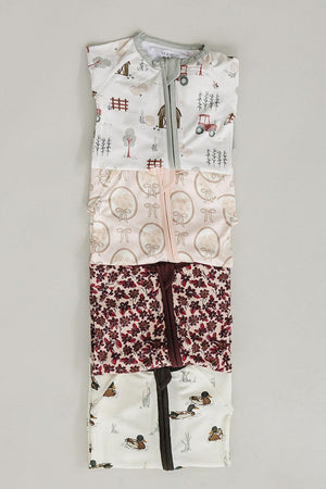 A collection of bamboo zippered baby pajamas featuring a mix of whimsical patterns in soft colors, designed for comfort and easy diaper changes. Ideal for eco-conscious families.