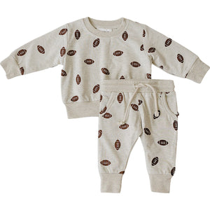 Light gray French terry cotton set featuring a playful football print, including a long-sleeve sweatshirt and matching pants. Ideal for kids, it offers soft comfort for everyday wear.