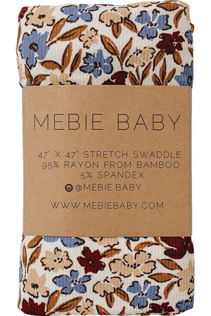 Floral patterned swaddle with blue, red, and brown flowers, wrapped in Mebie Baby branded packaging made from bamboo fabric.