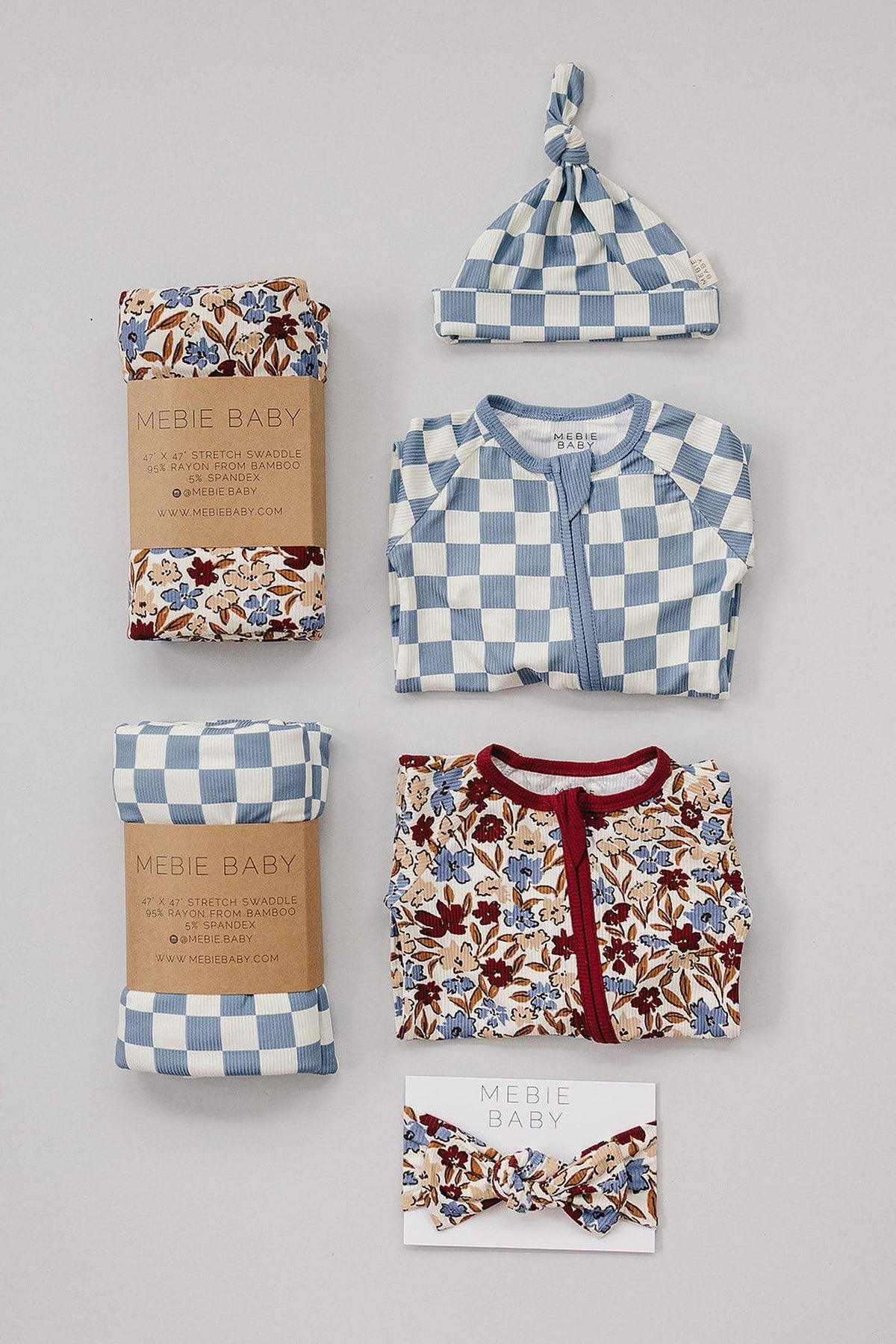 Blue checkered newborn knot hat with matching outfit, floral swaddles, and headband, made from bamboo rayon.