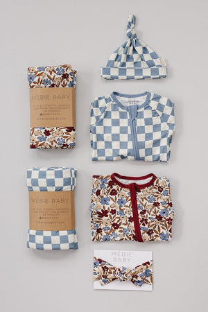 Blue checkered newborn knot hat with matching outfit, floral swaddles, and headband, made from bamboo rayon.
