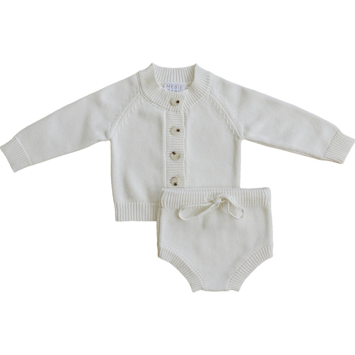 A soft, creamy white knit cotton baby set featuring a button-down sweater and matching bloomers. Perfect for everyday wear, this timeless outfit combines comfort and classic style for little ones.