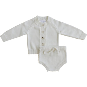 A soft, creamy white knit cotton baby set featuring a button-down sweater and matching bloomers. Perfect for everyday wear, this timeless outfit combines comfort and classic style for little ones.