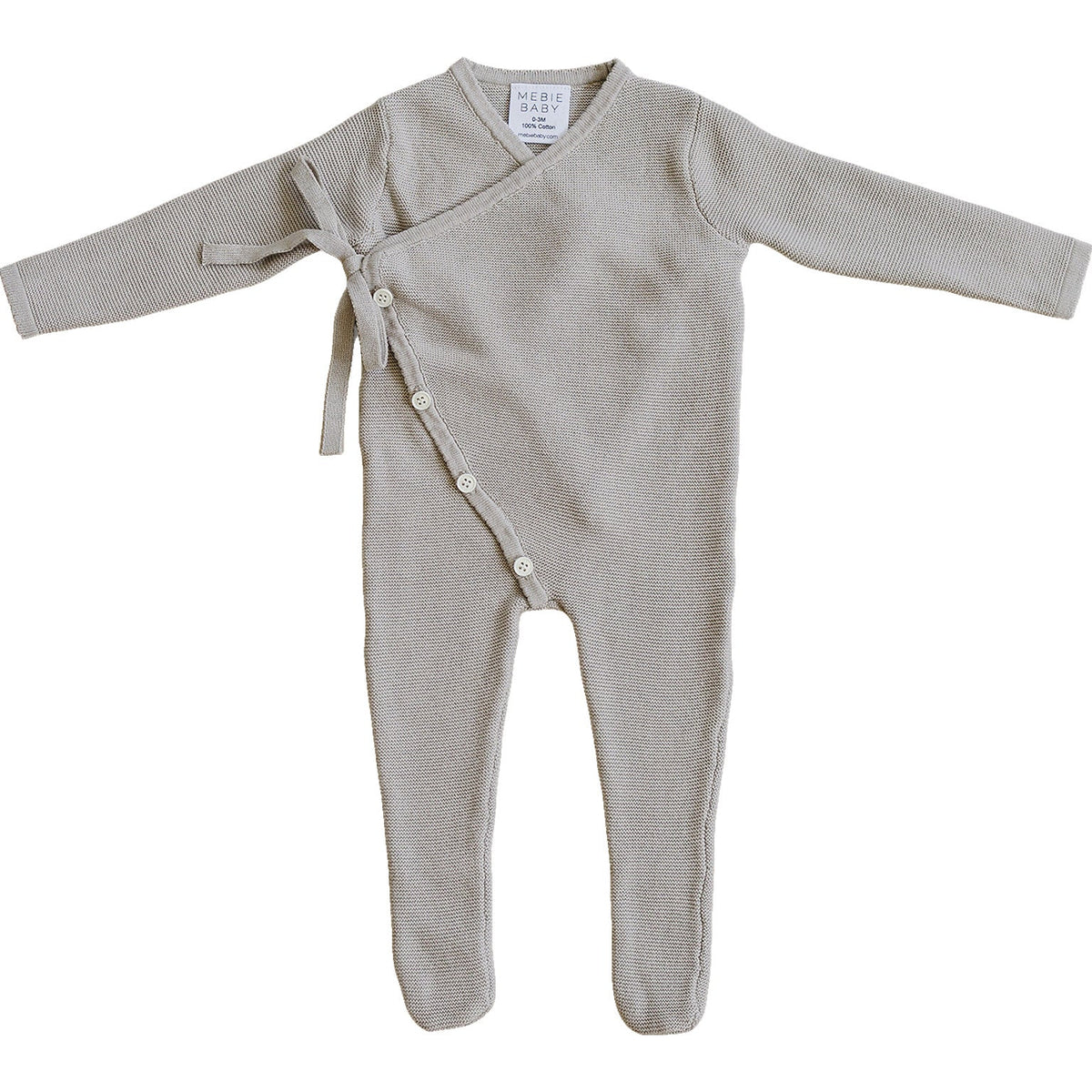 A soft, taupe cotton knit romper features a wrap design with an adjustable tie, long sleeves, and button closures. Ideal for babies, it combines comfort and style for everyday wear.