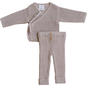 Soft, mauve cotton knit baby set featuring a textured wrap cardigan and ribbed leggings with button details.