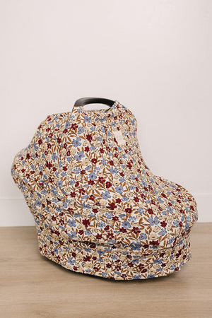 Floral-patterned cover with blue and red flowers on a car seat, featuring a handle and neutral background.