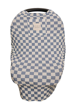 A blue and white checkered bamboo multi-use cover drapes over a car seat, showcasing its soft, breathable fabric and versatile.