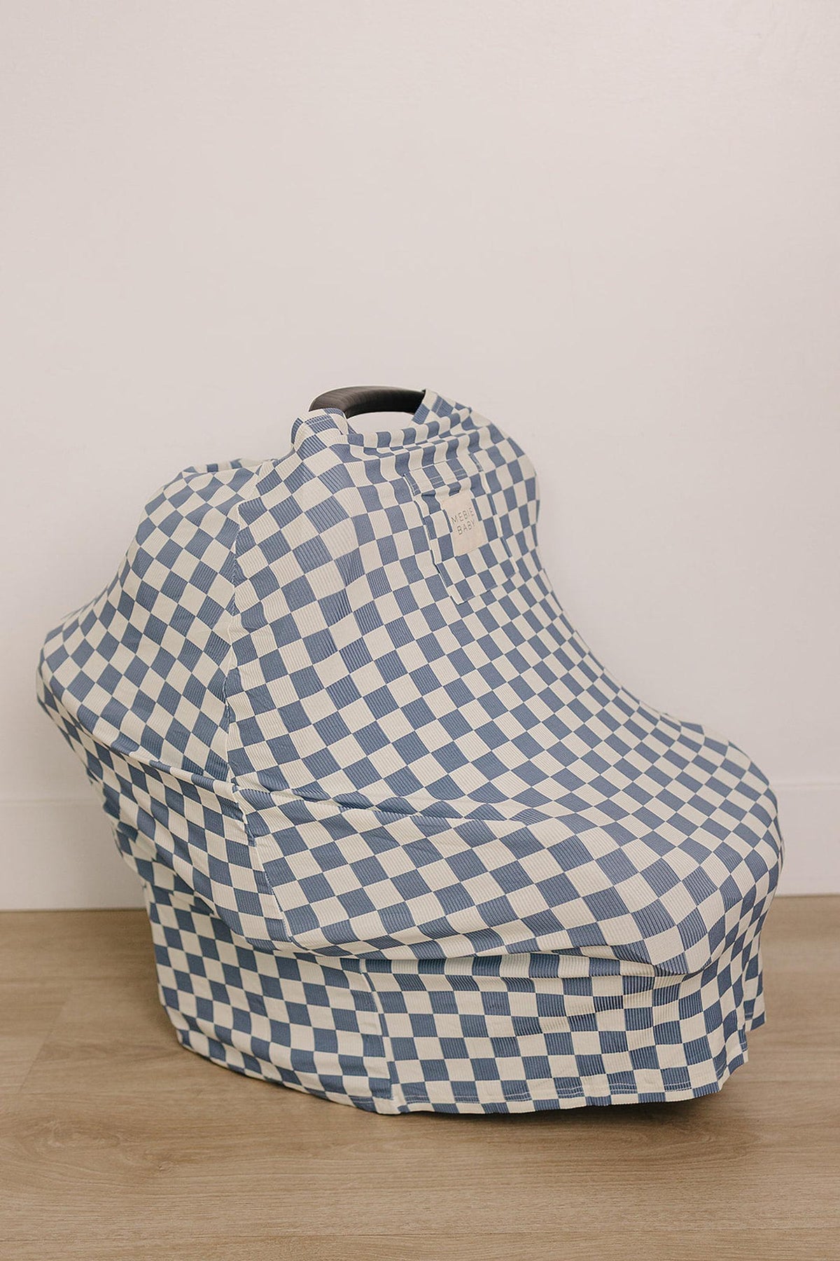 Blue checkered cover on a car seat, made from ribbed bamboo fabric, set against a light background.