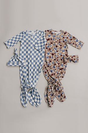 Two baby gowns displayed on a neutral background: one blue checkered and one floral pattern, both made of soft bamboo.