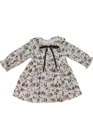 The image features a brown toile long-sleeve dress with a delicate vintage-inspired pattern of trees and landscapes. It has a gathered waist and a tied bow for added charm.