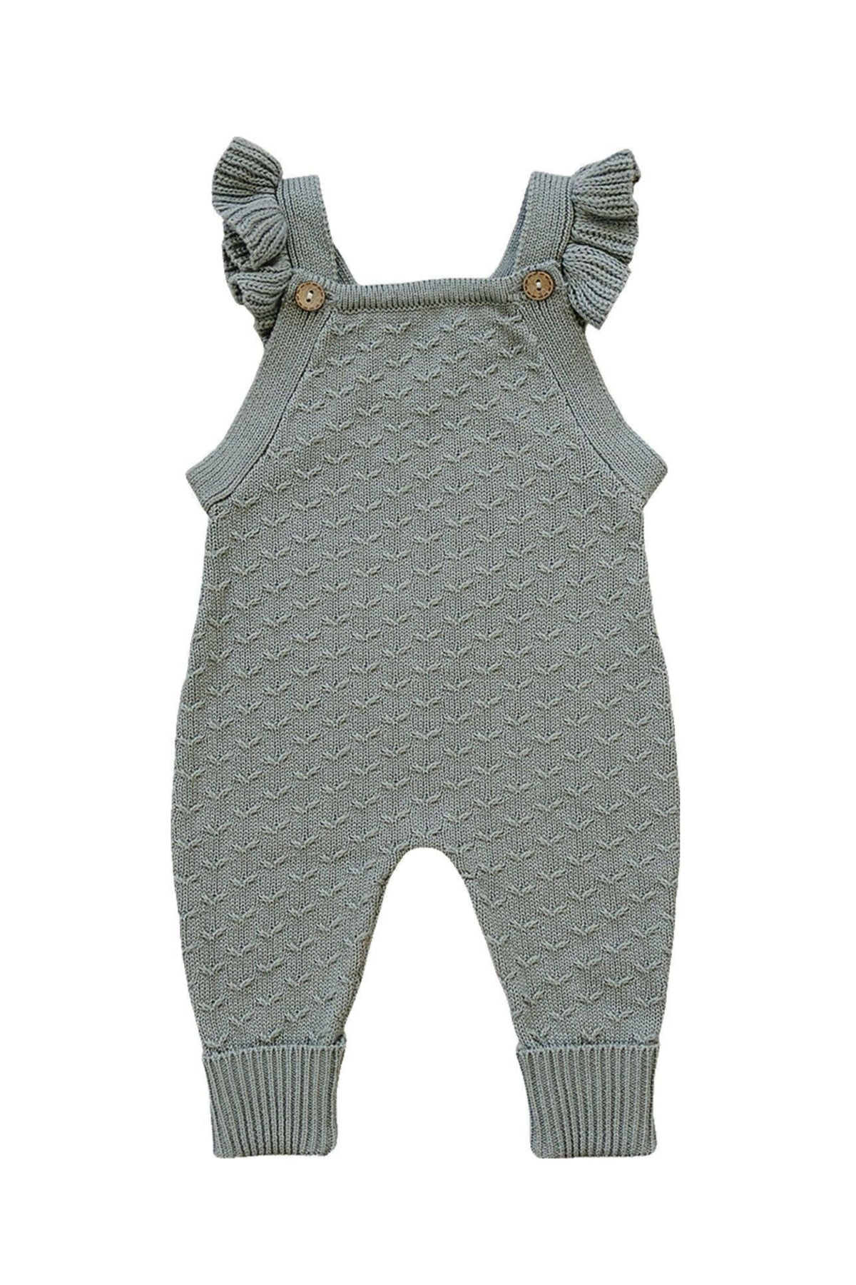 Green knit baby overalls with ruffle straps and wooden buttons, made from soft cotton fabric.