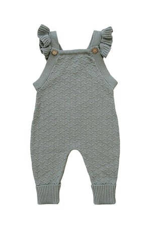 Green knit baby overalls with ruffle straps and wooden buttons, made from soft cotton fabric.